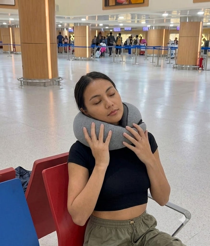 Traveler resting with her head supported by the Avemos pillow